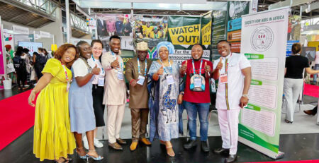 Mr. Luc Armand H. Bodea, ICASA Director/SAA Coordinator, Prof. Sheila Tlou, Board of Trustee; Madam Clemence A. Assogba, Head of Finance/ Admin;Chris K. Nuatro, Partnership/Marketing Officer in a group photograph with some delegates at the SAA booth no. 209, AIDS 2024 Conference.